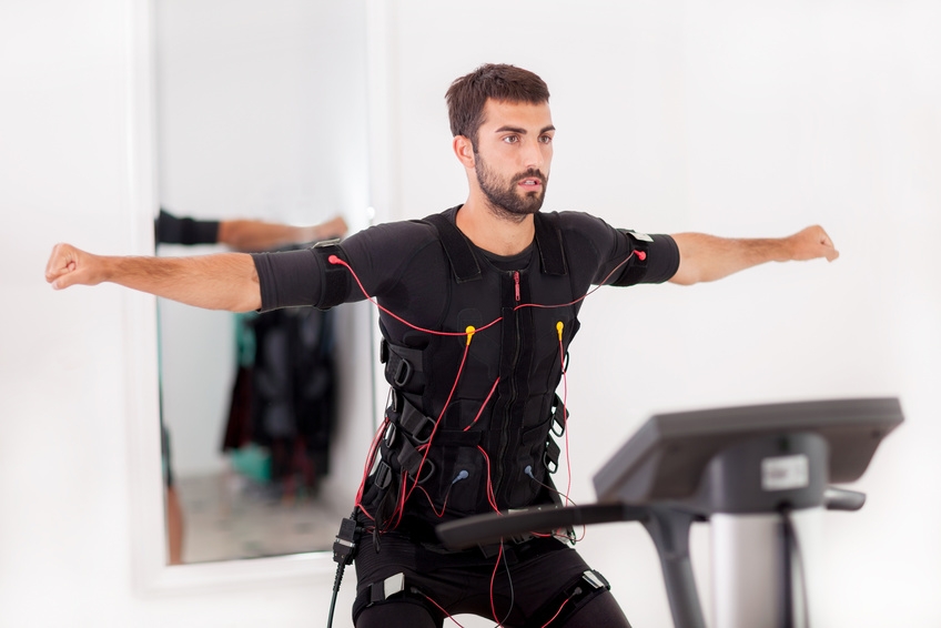 fit man exercise on  electro muscular stimulation machine